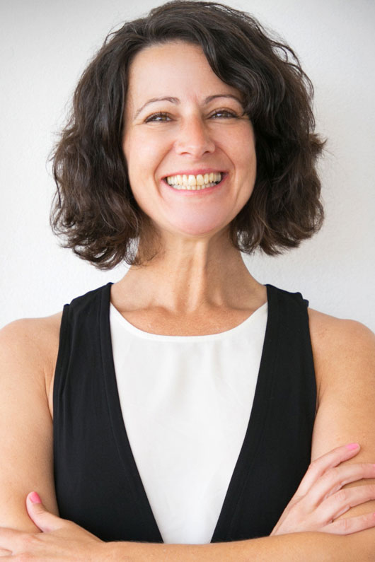 Happy joyful woman in casual posing over white studio background. Portrait of cheerful successful middle aged business lady with arms folded smiling at camera. Female portrait concept